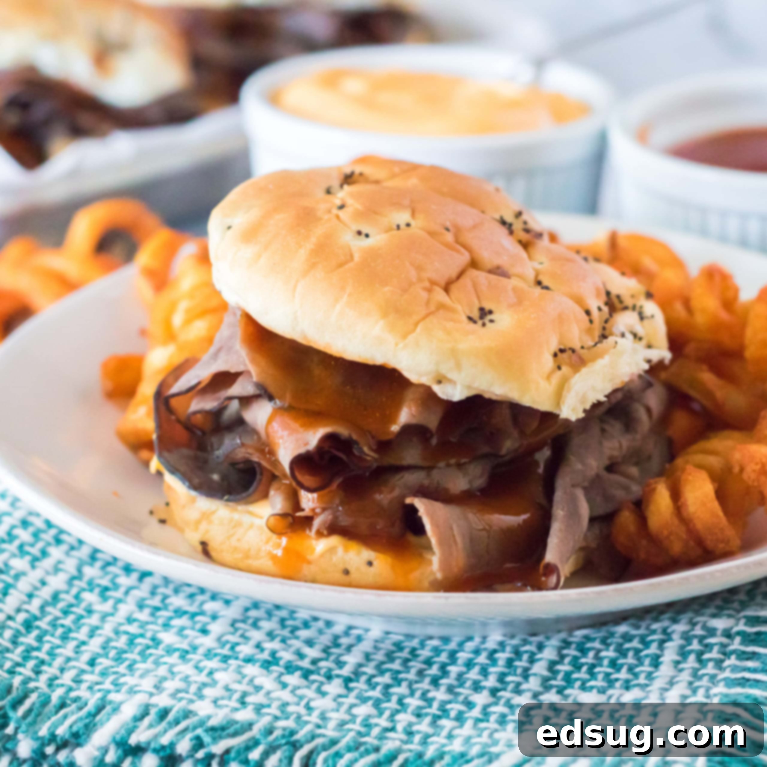 A delicious close-up of an Arby's Beef & Cheddar sandwich, showcasing the roast beef and melted cheddar cheese.