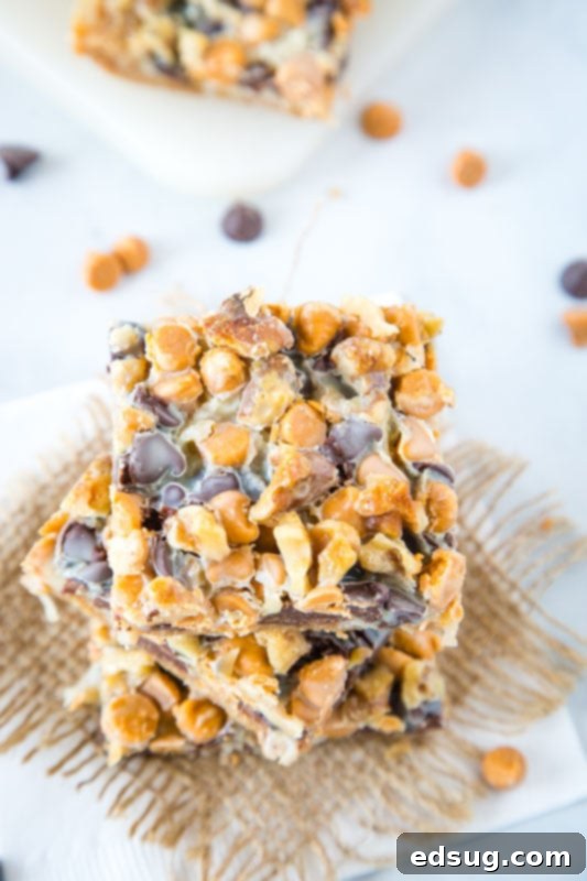 The Ultimate Layered Bars 3 7 layer magic cookie bars featuring melted chocolate and butterscotch chips with visible coconut and nuts, ready to be enjoyed