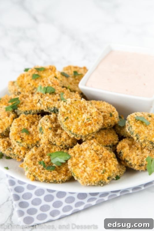 Freshly sliced zucchini on a plate, ready for preparation.