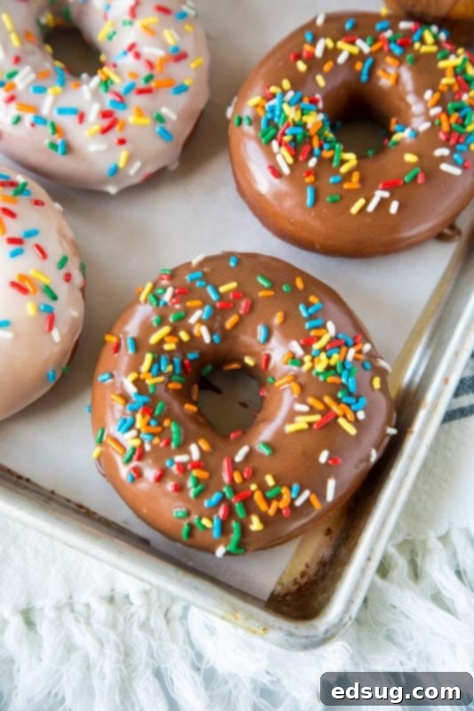 Doughnut Delights from Scratch 2 Warm homemade yeast donuts with vanilla and chocolate icing, ready to be enjoyed.