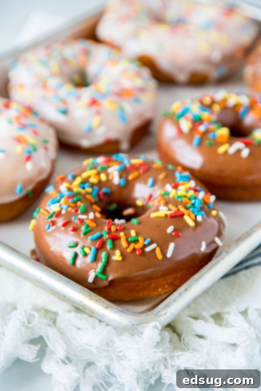 Doughnut Delights from Scratch 4 Delicious homemade donuts topped with vanilla icing and colorful sprinkles, ready to be served.