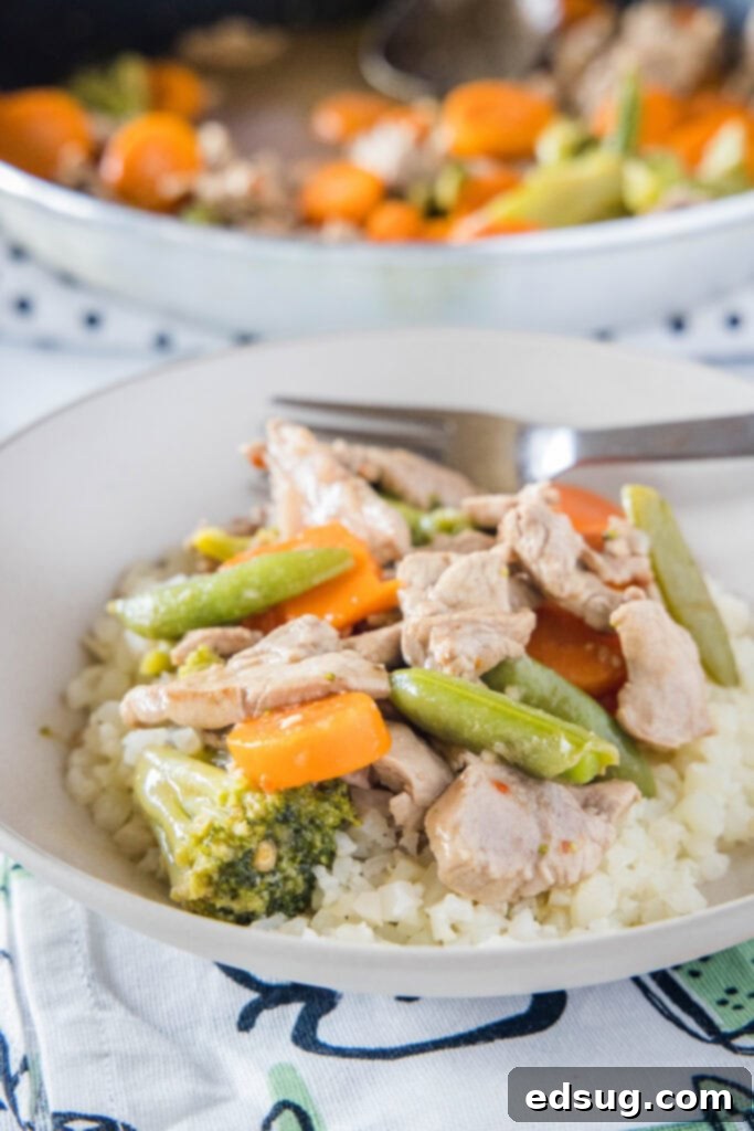a white bowl with pork stir fry