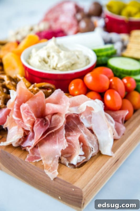 Prosciutto and grape tomatoes on a meat and cheese board