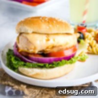 Signature Grilled Chicken Sandwich 6 A perfectly assembled grilled chicken sandwich on a plate