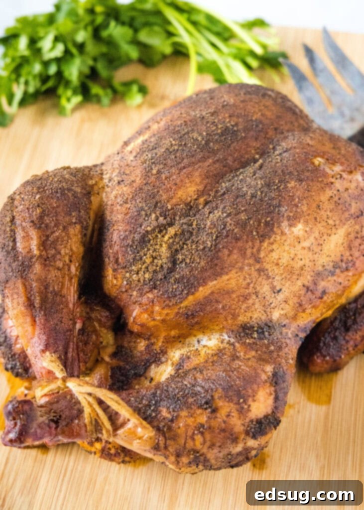 Smoked Chicken Perfection 2 A perfectly cooked whole smoked chicken on a rustic cutting board, ready to be carved