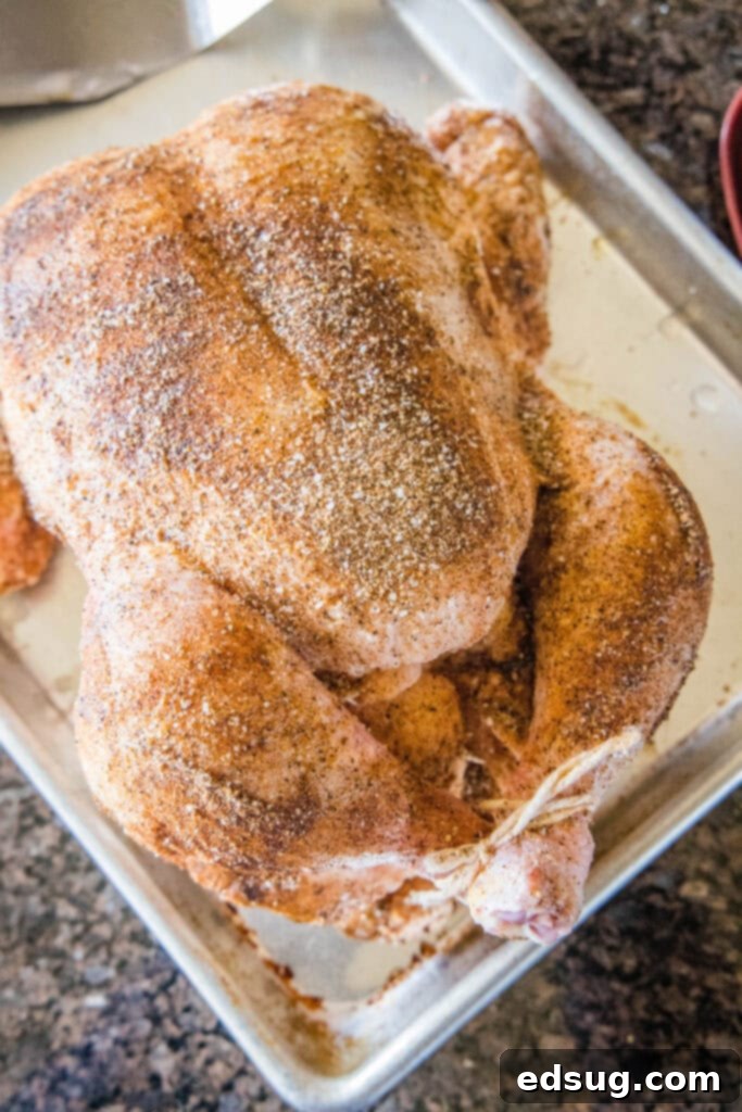 Smoked Chicken Perfection 3 A whole chicken generously seasoned with a spice rub, ready for the smoker