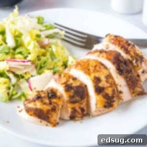 Smoked Chicken Perfection 8 close up sliced chicken on a white plate with a fork