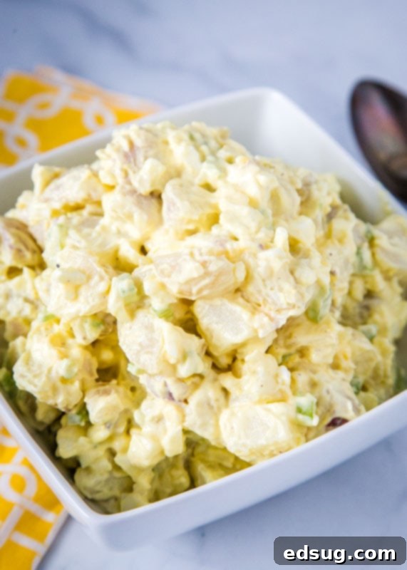 Timeless Potato Salad 2 Old fashioned potato salad in white bowl with yellow napkin