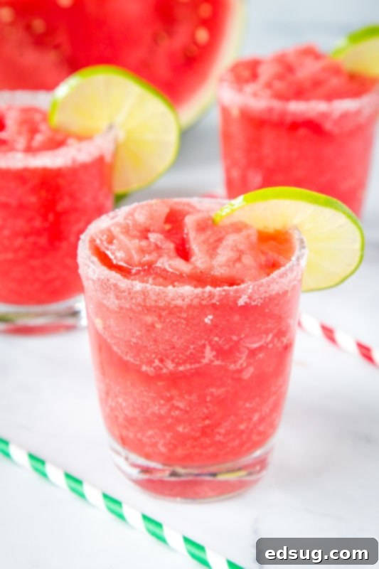 Fresh Watermelon Margaritas 5 A vibrant watermelon margarita in a glass, garnished with a fresh lime slice, epitomizing a perfect summer beverage.