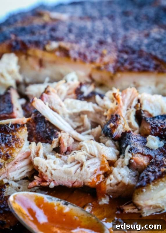 Smokehouse Pork Belly 2 Smoked pulled pork on a cutting board, ready to be served or prepared