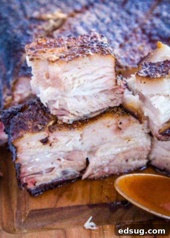 Smokehouse Pork Belly 5 Smoked pork belly cut into cubes on a cutting board