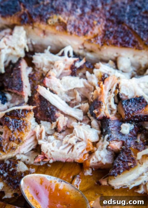 Smokehouse Pork Belly 6 Smoked pulled pork on a cutting board, ready for serving