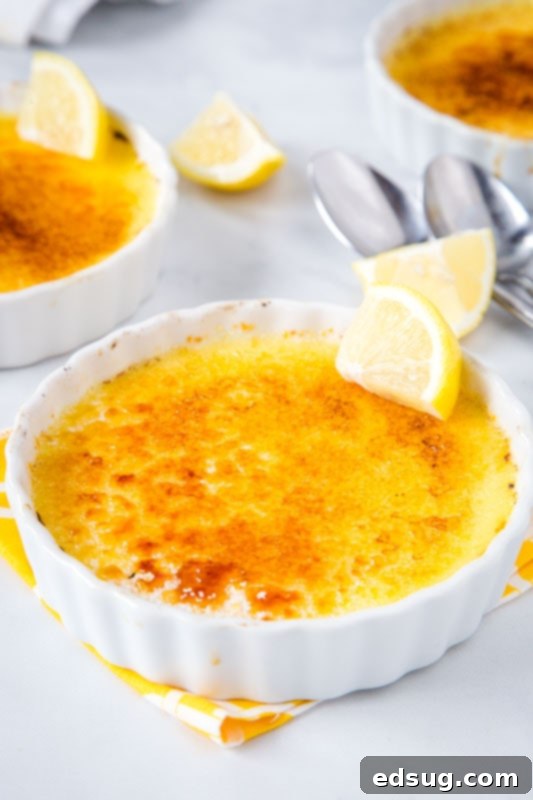 Zesty Lemon Crème Brûlée 2 lemon flavored creme brulee in white bowl with slice of lemon