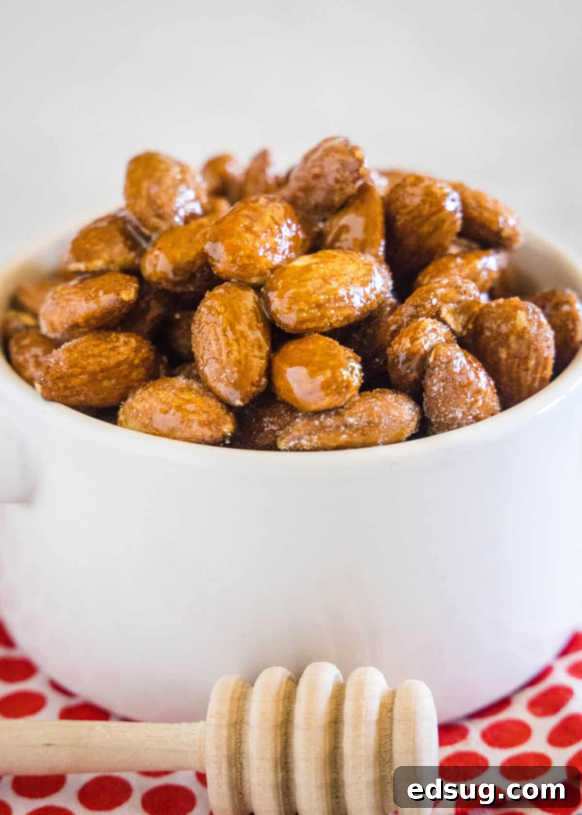 Spicy Honey Roasted Almonds labeled A beautifully arranged bowl of spicy honey roasted almonds, glistening with a sweet and spicy glaze, ready to be enjoyed.