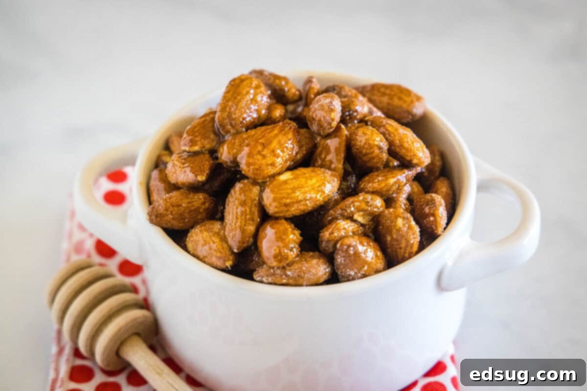 Spicy Honey Roasted Almonds 2 A close-up shot of a small bowl filled with spicy honey roasted almonds, showcasing their crunchy texture and sweet-spicy glaze.