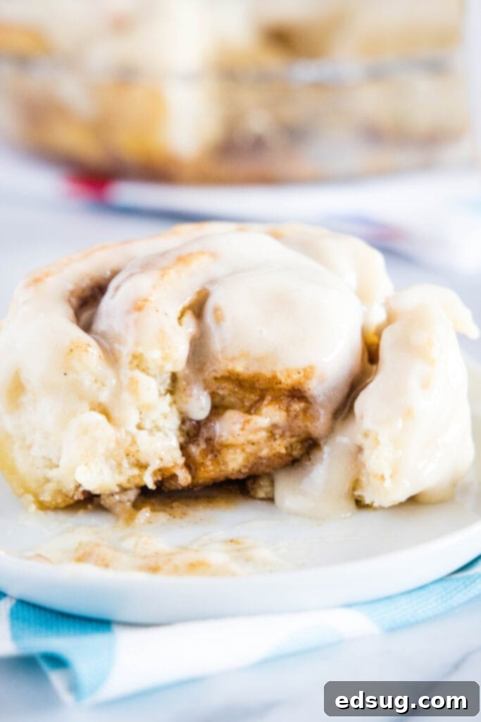 Warm Cinnamon Swirls 2 cinnamon roll on a plate with bite missing