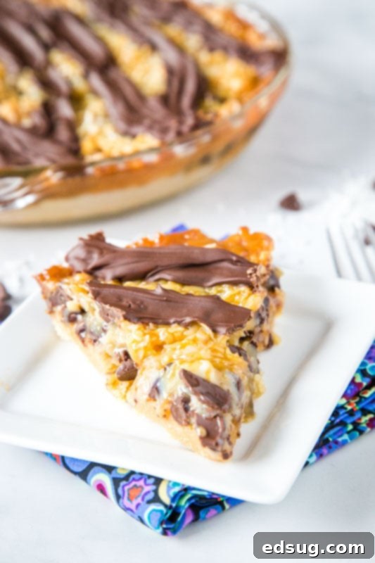 slice of samoa pie on a white plate with visible layers