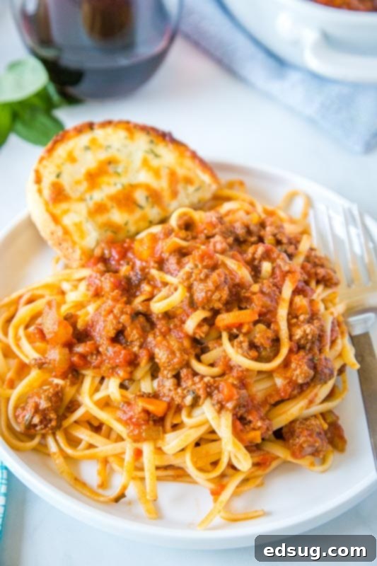 Quick Instant Pot Bolognese 5 A serving of pasta with Instant Pot Bolognese sauce, fork ready, showing a comforting weeknight meal.