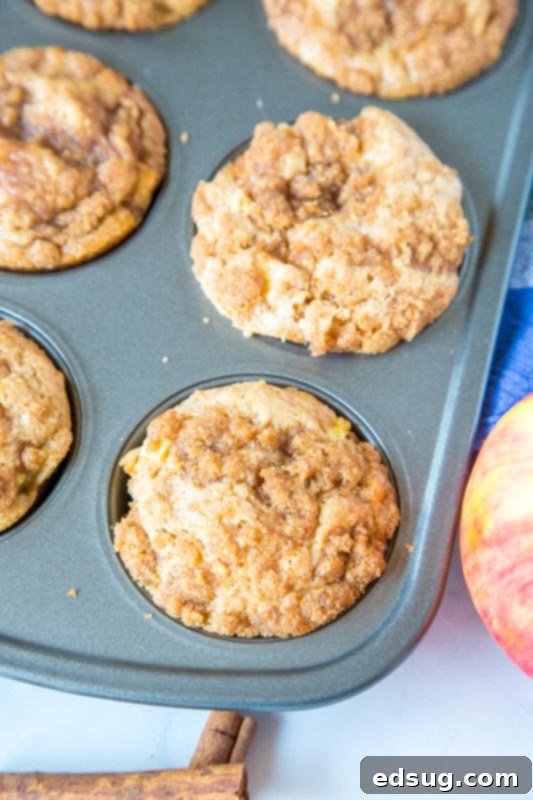 Warm Apple Cinnamon Muffins 3 Apple cinnamon muffins baking in a muffin tin