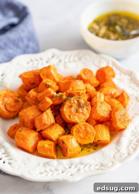 Perfect Air Fryer Carrots 5 roasted carrots on white plate with pesto butter