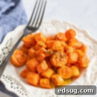 cooked carrots on a plate with fork
