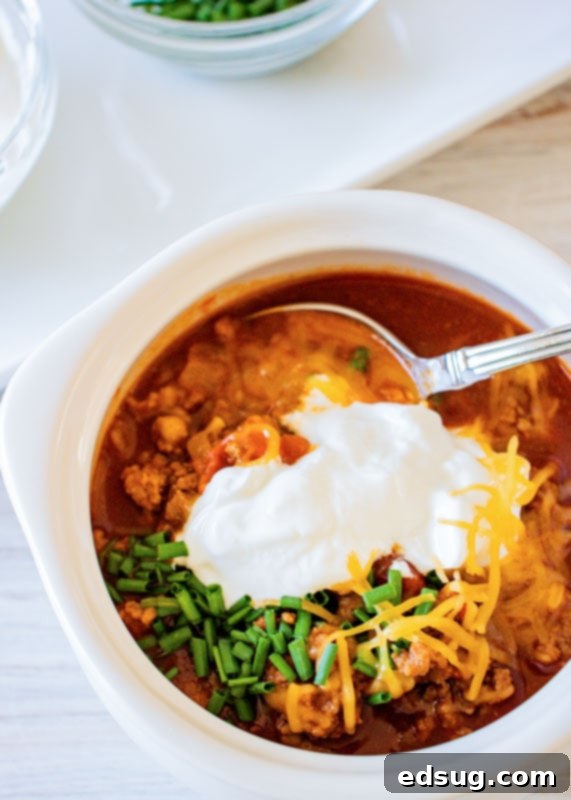 Instant Pot Turkey Chili 2 turkey chili topped with sour cream and chives in a bowl