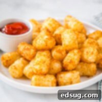 Air Fryer Tater Tots - make the BEST tater tots in the air fryer with this fool proof method. Frozen tater tots will turn out crispy and delicious every time!