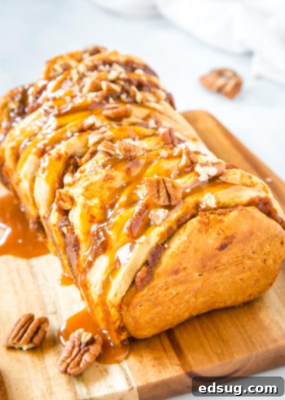 Golden pumpkin pull apart bread with caramel and pecans, ready to be served for fall
