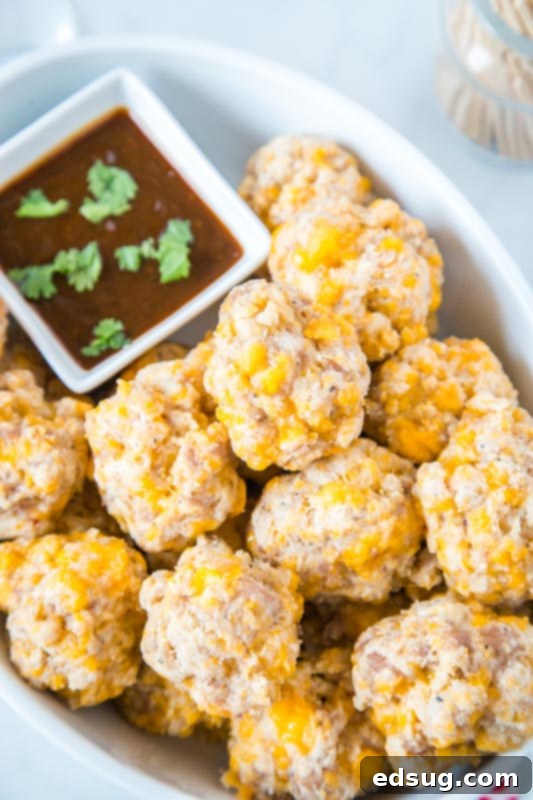Cream Cheese Sausage Balls 5 cream cheese sausage balls in white dish with barbecue sauce