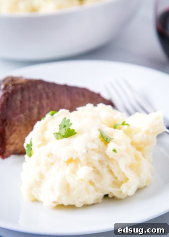 Velvet Smooth Sous Vide Mashed Potatoes 4 scoop of mashed potatoes on a plate with steak