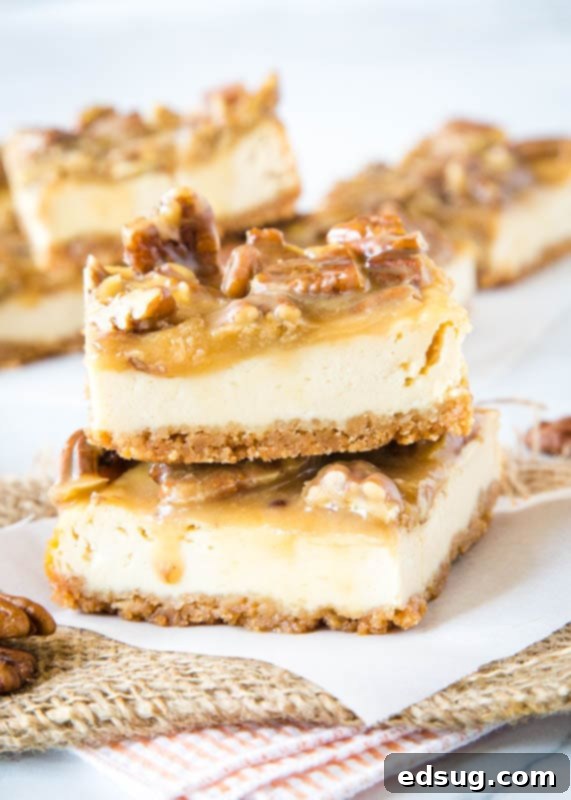 praline cheesecake bars staked on white paper