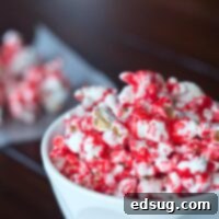 Rachael Ray's cinnamon popcorn in a festive bowl, coated in a glossy red candy shell