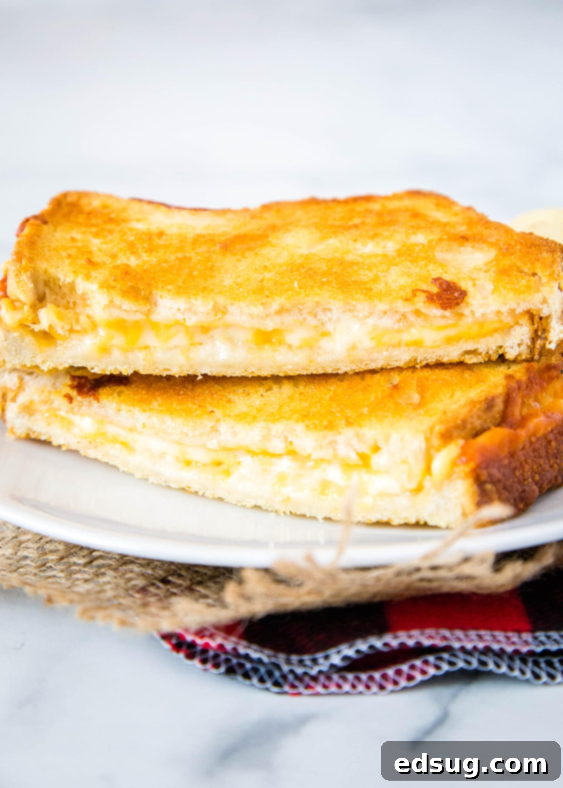 Crispy Air Fryer Grilled Cheese 4 grilled cheese sandwich on a white plate