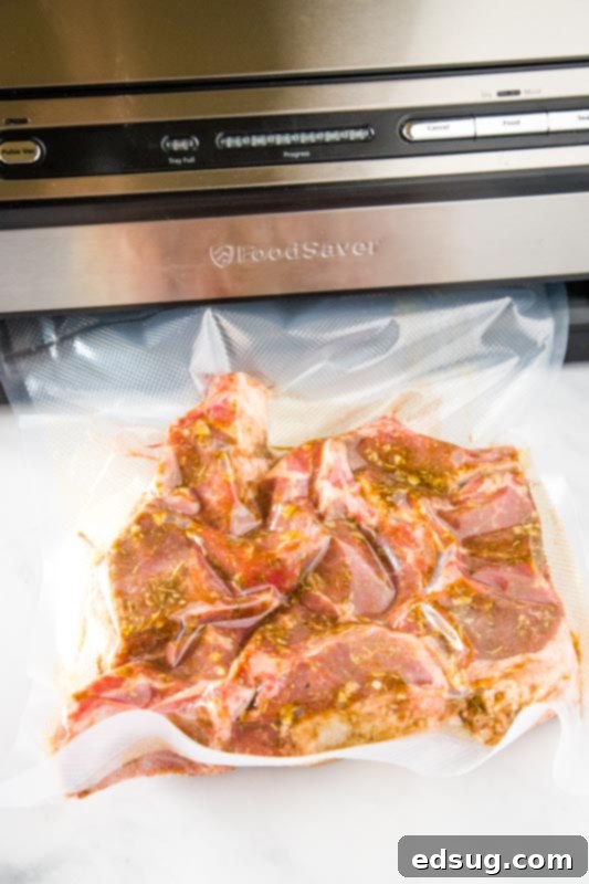 Freshly seasoned lamb chops sealed inside a food saver bag, ready for the sous vide water bath.