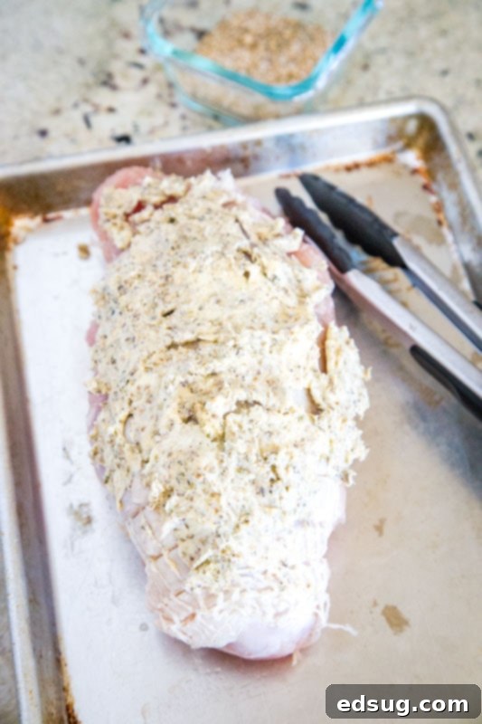 Artisan Smoked Turkey Breast 4 Turkey breast submerged in a flavorful brine mixture in a large bowl.