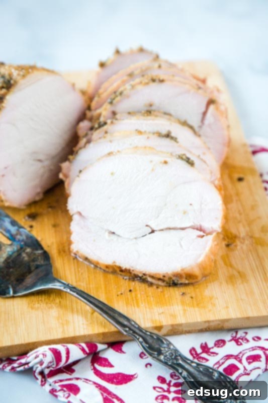 Artisan Smoked Turkey Breast 6 Beautifully sliced smoked turkey breast on a rustic cutting board.