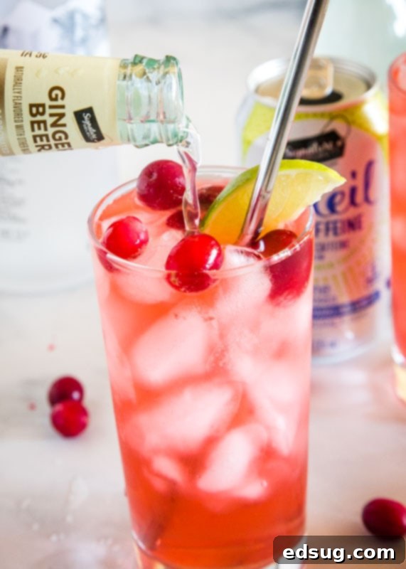 cranberry vodka spritzer with ginger beer being poured in