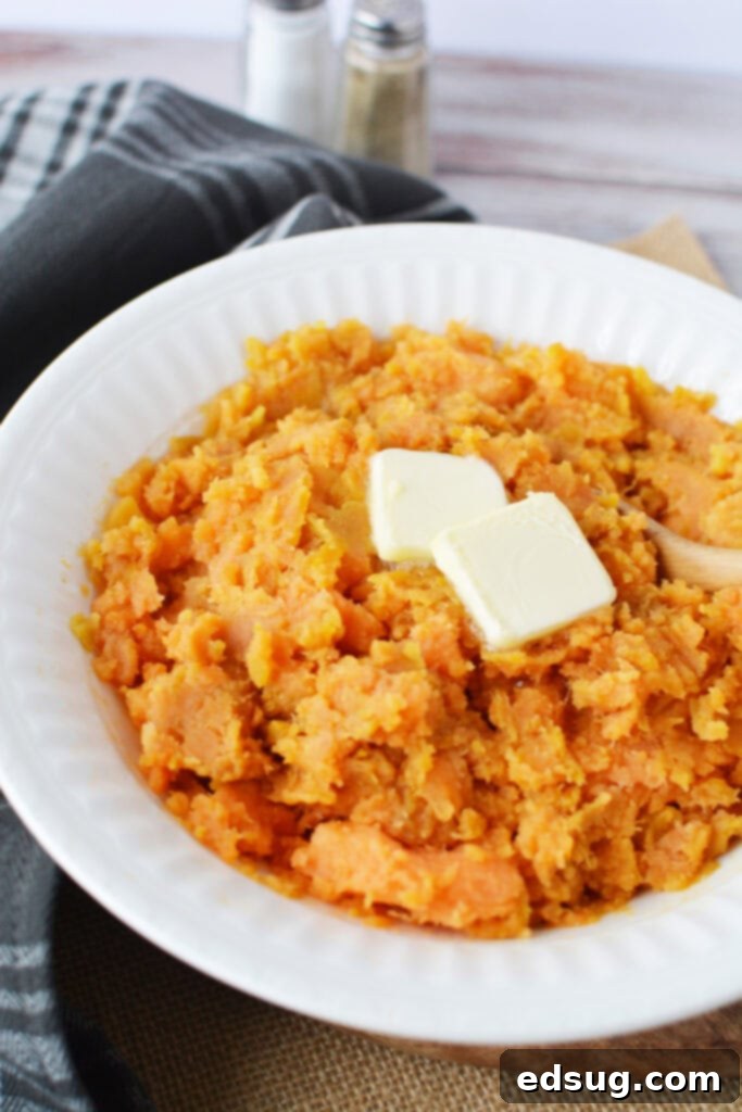 The Easiest Instant Pot Sweet Potatoes 4 Bowl of creamy mashed sweet potatoes topped with melted butter, ready to enjoy