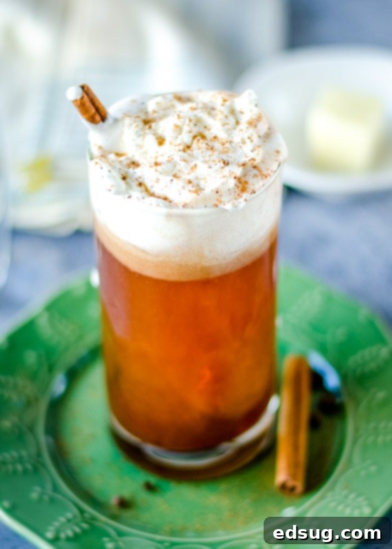 Spiced Buttered Bliss 2 Hot buttered rum topped with whipped cream, ready to be enjoyed
