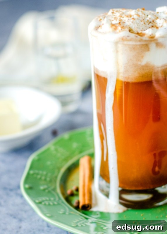 Spiced Buttered Bliss 6 hot buttered rum in a glass on a green plate, garnished