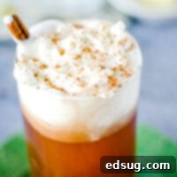 cropped image of hot buttered rum in glass with whipped cream