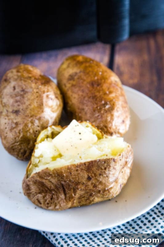 Crispy Air Fryer Baked Potato 6 potato with pat of butter on it