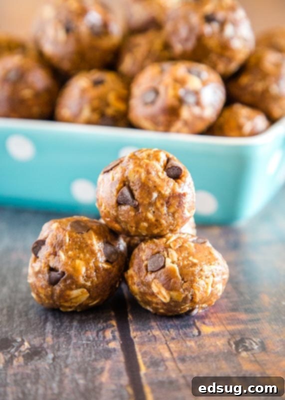 Energy-Boosting Almond Butter Bites 2 protein balls stacked on wood table - delicious and easy no-bake almond butter protein balls