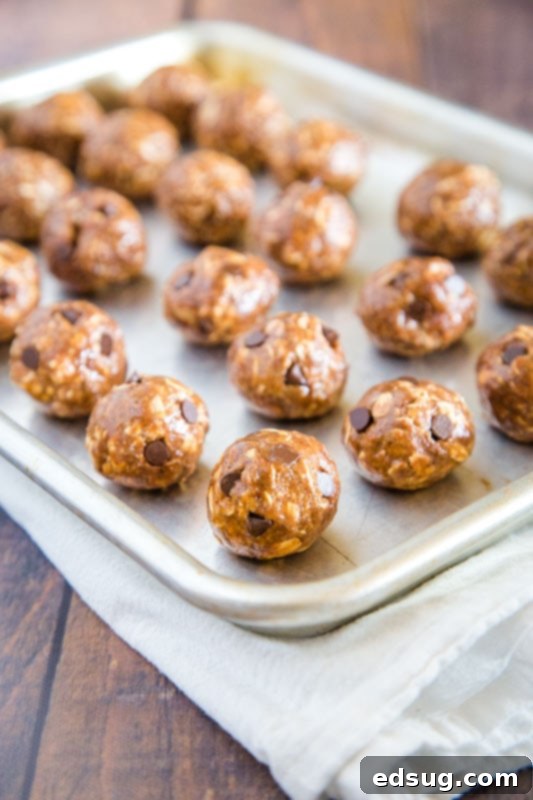 Energy-Boosting Almond Butter Bites 5 protein balls rolled on baking sheet - chilling to perfection