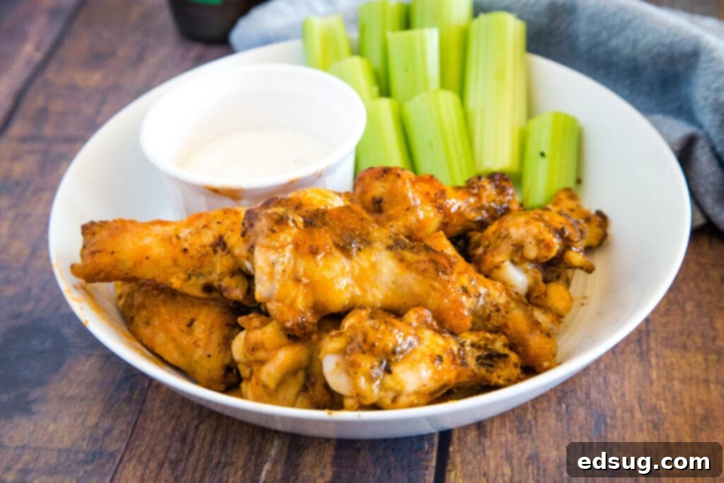 Crispy Air Fryer Chicken Wings 5 buffalo chicken wings on plate with celery sticks and ranch