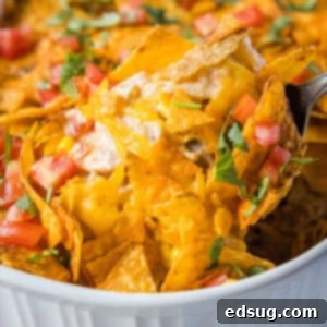 Crunchy Dorito Chicken Bake 7 scooping dorito chicken casserole out of dish