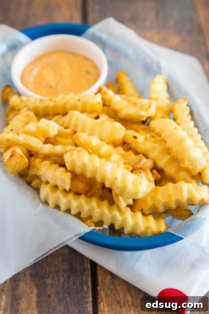 A basket brimming with golden-brown, perfectly cooked air fryer French fries, ready to be enjoyed.