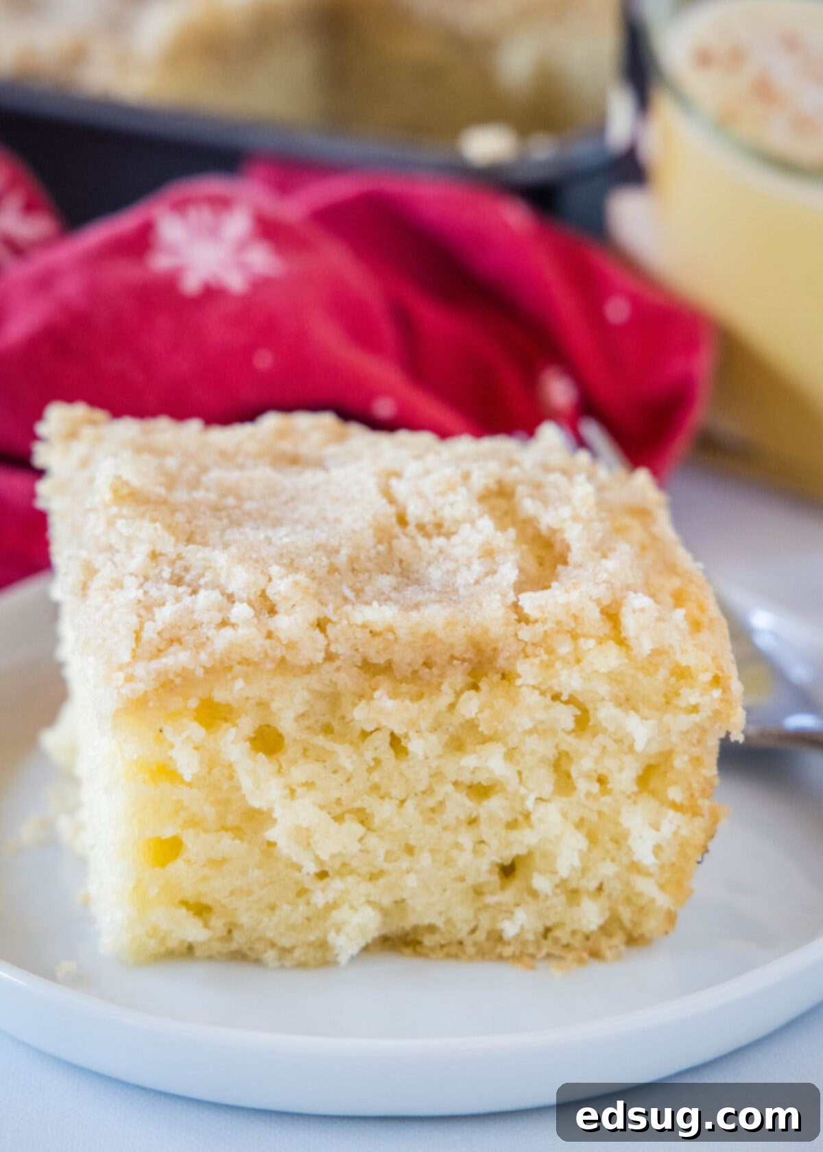Eggnog Coffee Cake | @dinnersdishesdessert a piece of eggnog coffee cake on a plate