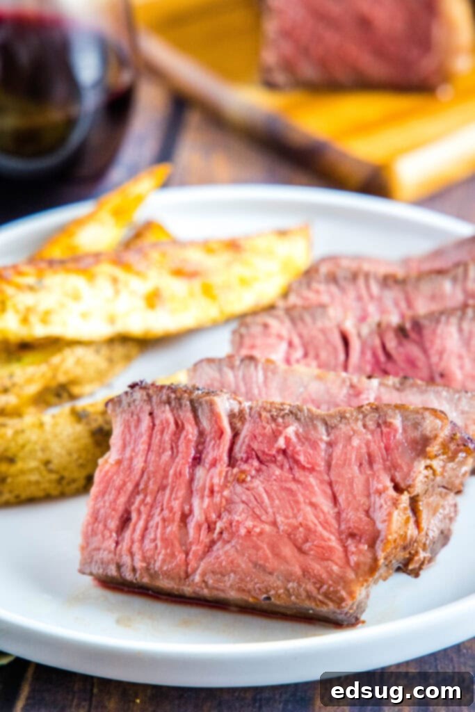 Sous Vide Steak Perfection 2 perfectly cooked sous vide steak sliced on a plate, showcasing ideal edge-to-edge doneness