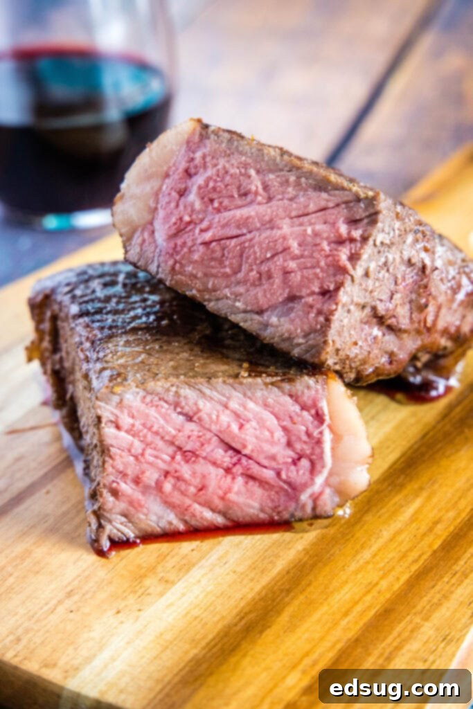 Sous Vide Steak Perfection 6 perfectly cooked sous vide steak cut in half on a cutting board, revealing uniform pink doneness from edge to edge